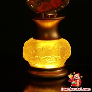 Thân đèn khắc họa sen nổi, ánh sáng vàng ấm tạo cảm giác thanh tịnh